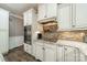 Well-equipped kitchen with white cabinets, granite counters, stainless steel oven, and stone backsplash at 134 Lawrence Tee Ln, Mooresville, NC 28117