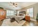 Comfortable main bedroom featuring a ceiling fan, wood floors, and plush rug at 134 Lawrence Tee Ln, Mooresville, NC 28117