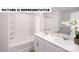 A well-lit bathroom with double sinks, white cabinets, a bathtub, and white tile at 135 Way Cross Ln, Troutman, NC 28166