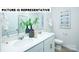 Modern bathroom features a double vanity, decorative fixtures, and a large framed mirror at 135 Way Cross Ln, Troutman, NC 28166