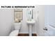 Charming powder room featuring a pedestal sink, decorative accents, and stylish fixtures at 135 Way Cross Ln, Troutman, NC 28166