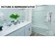 Bright bathroom features a double sink vanity with chrome fixtures and a shower-tub combination at 135 Way Cross Ln, Troutman, NC 28166