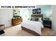 This bedroom features a light color palette, a nightstand, a queen-size bed, and modern art at 135 Way Cross Ln, Troutman, NC 28166