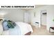 This bedroom features an open closet space, a queen-size bed, neutral colors, and large windows at 135 Way Cross Ln, Troutman, NC 28166