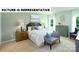 This bedroom features a large window, nightstands, bench, queen-size bed, and a light color palette at 135 Way Cross Ln, Troutman, NC 28166