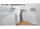 An open closet with wire shelving and two robes hanging inside at 135 Way Cross Ln, Troutman, NC 28166