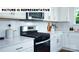 Well-equipped kitchen features stainless steel appliances, white cabinets, and a stylish subway tile backsplash at 135 Way Cross Ln, Troutman, NC 28166