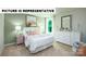 Bright bedroom features a decorative dresser and soft lighting from a large window at 135 Way Cross Ln, Troutman, NC 28166