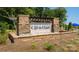 Attractive stone community entrance sign with waterfall feature and professional landscaping at 135 Way Cross Ln, Troutman, NC 28166