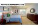 Stylishly decorated bedroom with a modern bed frame, dresser, and decor, creating a comfortable retreat at 143 Way Cross Ln, Troutman, NC 28166