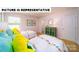 Charming bedroom setup with twin beds, decorated with colorful accents and plenty of natural light at 143 Way Cross Ln, Troutman, NC 28166