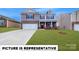 Charming two-story home showcasing a well-manicured lawn and a classic brick and siding exterior at 143 Way Cross Ln, Troutman, NC 28166