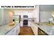 Modern kitchen featuring stainless steel appliances, hardwood flooring, and granite countertops at 143 Way Cross Ln, Troutman, NC 28166