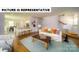 Bright living room featuring an open concept floorplan, a staircase and a large sofa at 143 Way Cross Ln, Troutman, NC 28166