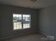Bedroom with a large window offering a view of the neighborhood at 144 Mason Tanner Ct, Rock Hill, SC 29730