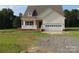 Charming home featuring light siding, a covered porch, and an attached garage with ample parking space at 144 Mason Tanner Ct, Rock Hill, SC 29730