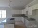 Modern kitchen with white cabinets, granite countertops and island perfect for food preparation at 144 Mason Tanner Ct, Rock Hill, SC 29730