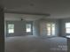 Open-concept living room with double doors to backyard and windows offering plenty of natural light at 144 Mason Tanner Ct, Rock Hill, SC 29730