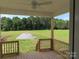 Covered porch featuring wood floors, wood railing, and a beautiful view of a lush green lawn and surrounding trees at 144 Mason Tanner Ct, Rock Hill, SC 29730