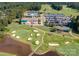 An aerial view of community amenities, including a clubhouse, golf course, pool, and tennis courts at 15406 Pepperwood Ct, Huntersville, NC 28078