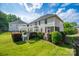 Spacious backyard with a pergola, screened porch, and well-maintained lawn, ideal for outdoor enjoyment at 15406 Pepperwood Ct, Huntersville, NC 28078