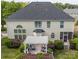 Aerial view of a backyard featuring a pergola with outdoor seating, a screened-in porch, and lush greenery at 15406 Pepperwood Ct, Huntersville, NC 28078