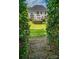 A charming backyard featuring a well-manicured lawn and a lovely pergola, perfect for relaxation at 15406 Pepperwood Ct, Huntersville, NC 28078