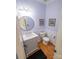Powder room features hardwood floors, vanity and toilet with chair-rail accents at 15406 Pepperwood Ct, Huntersville, NC 28078