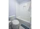 Bathroom featuring a white subway tiled tub and shower with a white toilet and blue accent rug at 15406 Pepperwood Ct, Huntersville, NC 28078