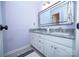 Bathroom features double sinks, granite countertops, and a large mirror offering practical elegance at 15406 Pepperwood Ct, Huntersville, NC 28078