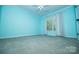 Well-lit bedroom with a ceiling fan and bright blue walls at 15406 Pepperwood Ct, Huntersville, NC 28078