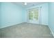 Well-lit bedroom with neutral carpet, light blue walls, and a large window brings lots of natural light at 15406 Pepperwood Ct, Huntersville, NC 28078
