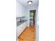 Butler's pantry with white cabinets, granite countertop, and hardwood floors at 15406 Pepperwood Ct, Huntersville, NC 28078