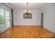 Formal dining room featuring hardwood floors, a chandelier, and wainscoting at 15406 Pepperwood Ct, Huntersville, NC 28078