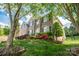 Brick home with well-maintained landscaping, colorful flowers, and a charming front entrance at 15406 Pepperwood Ct, Huntersville, NC 28078