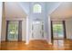 Bright and airy foyer with soaring ceilings, elegant columns, and hardwood flooring at 15406 Pepperwood Ct, Huntersville, NC 28078