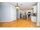 Open eat-in kitchen features stainless appliances, granite counters, gray island and hardwood floors at 15406 Pepperwood Ct, Huntersville, NC 28078