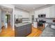 Well-lit kitchen boasts stainless appliances, granite counters and gray island, with open view to the other rooms at 15406 Pepperwood Ct, Huntersville, NC 28078
