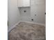 A functional laundry room with neutral walls and space for appliances at 15406 Pepperwood Ct, Huntersville, NC 28078