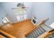 Upper view of living room featuring fireplace, wood floors, high ceilings and staircase to second level at 15406 Pepperwood Ct, Huntersville, NC 28078