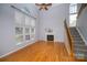 Sun-drenched living room with wood floors, gas fireplace and staircase to upper level at 15406 Pepperwood Ct, Huntersville, NC 28078