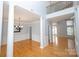 Open-concept living area with hardwood floors, columns, and wainscoting details at 15406 Pepperwood Ct, Huntersville, NC 28078