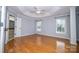 Spacious main bedroom with hardwood floors, tray ceilings, large windows, and adjoining bath at 15406 Pepperwood Ct, Huntersville, NC 28078