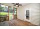Screened porch featuring wood flooring, ceiling fan and view of yard at 15406 Pepperwood Ct, Huntersville, NC 28078