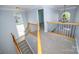Upper hall features carpet, chandelier and arched windows overlooking main level at 15406 Pepperwood Ct, Huntersville, NC 28078