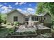 Backyard featuring a stone patio, serene landscaping, and a charming sunroom attached to the house at 160 Fernbrook Dr, Mooresville, NC 28117