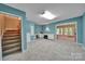 Spacious carpeted basement featuring a built-in desk, offering a versatile living and work space at 160 Fernbrook Dr, Mooresville, NC 28117