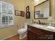 Powder room featuring wood floors, designer faucet, a granite countertop, and natural light at 160 Fernbrook Dr, Mooresville, NC 28117