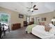 Cozy bedroom featuring plush carpet, ceiling fan, and access to a private balcony at 160 Fernbrook Dr, Mooresville, NC 28117