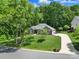 Charming brick home with manicured lawn, mature trees and long concrete driveway at 160 Fernbrook Dr, Mooresville, NC 28117